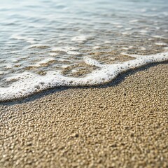 Ocean waves gently washing over golden sand on a sunny beach.
