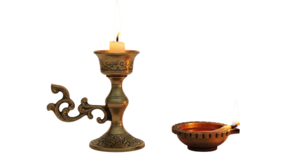 Old vintage candle holder with burning candle and small diya lamp offering warm light isolated on transparent background