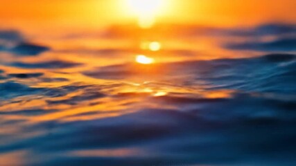 Close up of ocean waves reflecting golden sunlight at sunset