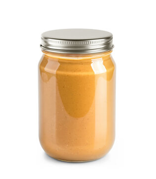 Clear Glass Jar Filled with Peanut Butter and with a metallic cap on a transparent background.