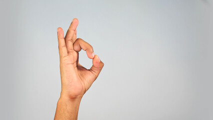 Naklejka premium Hand Gesture Showing Quality Sign — OK Symbol Close-Up on Studio Background