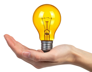 Hand holding a glowing yellow lightbulb, isolated against a solid black background