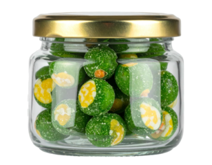 Small glass jar filled with green, coated, round snacks with golden lid
