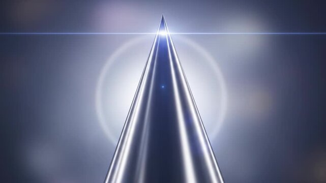 A metallic, conical object with bright highlights, a sharp tip, and a lens flare against a blurred, gradient background