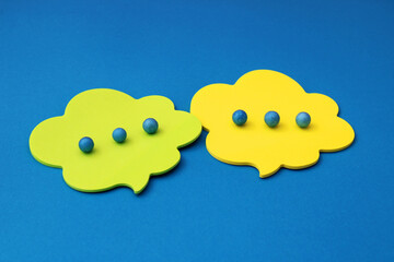 Conversation in speech bubbles with spheres simulating ellipses