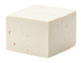 A close-up studio shot of a raw, rectangular block of off-white, textured food