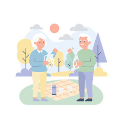 Smiling senior couple enjoys a healthy picnic in a park with refreshing infused water and fruit