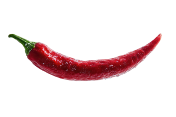 A long, curved red chili pepper isolated on black. Its stem is green, and tiny water droplets cling to its skin