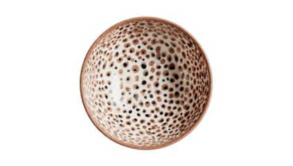 Spherical object with irregular patterned brown and black spots against a stark black background