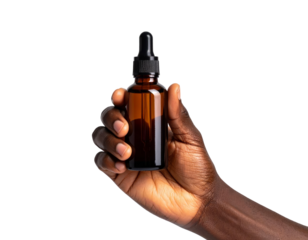 Dark-skinned hand holding a brown glass bottle with a dropper against black