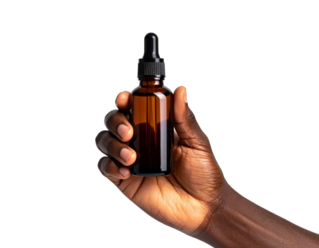 Dark-skinned hand holding a brown glass bottle with a dropper against black