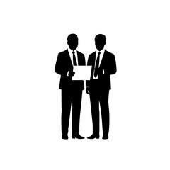 Silhouette of a person sitting at a desk with a laptop, working or studying.