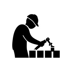 Silhouette of a person sitting at a desk with a laptop, working or studying.