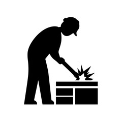 Silhouette of a person sitting at a desk with a laptop, working or studying.