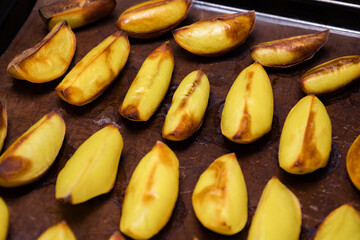 Perfectly roasted potato wedges on a baking tray, golden brown and crispy, ready to be served as a side dish or snack for any meal at home