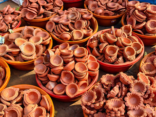 Clay lamp stall for festival celebration, Terracotta diyas or oil lamps for Diwali for sale at a market in India.
