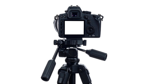 A professional camera mounted on a tripod, back view, with a blank screen, against black