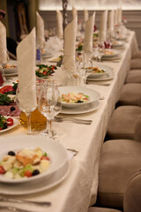 Elegant banquet table setting with salads and glassware