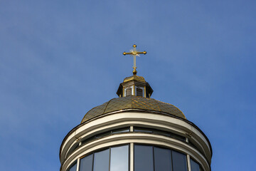 The dome of a Christian church against a blue sky. Horizontal shot.