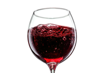 Close-up of a wine glass filled with red liquid, against a stark black background