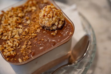 Chocolate nut soufflé with nut topping in a rectangular tray at a pastry shop