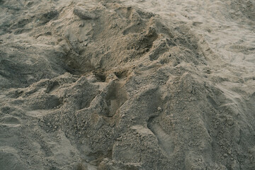 A sandy beach with a lot of small rocks and pebbles