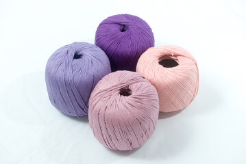 Bundles of Yarn in Pastel and Vibrant Purple on White Background