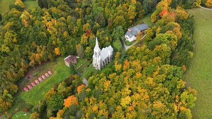 Aerial mountain valley village church Travna Czechia autumn 1. Czech Republic, Czechia historically known as Bohemia. Central Europe. Autumn fall season. Farm rural area landscape. Mountain valley.