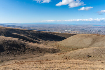 Rolling Hills South of Karakol with Valley and City Views in Late Autumn.