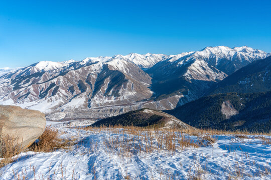 Snow-Covered Mountain Ridges in Tian Shan Range Near Ak Suu Under Clear Blue Sky in Late November.