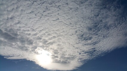 Ethereal Cloudscape Sunlight Breaking Through Cirrocumulus Clouds in a Blue Sky