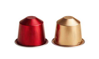 Two coffee capsules, one red and one gold, with shiny metal surfaces, against a black backdrop