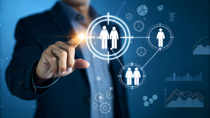 Businessman touching target customer icon on virtual screen, representing marketing strategy and customer relationship management concept