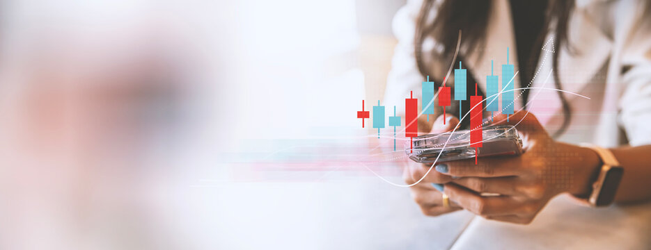 Mobile Stock Trading and Financial Growth Analytics Concept,
A businesswoman analyzes financial charts on her smartphone, representing mobile stock trading, investment analysis, and market growth. 