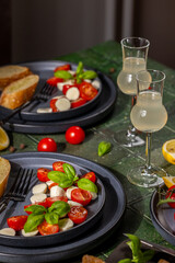 Caprese salad with mozzarella, basil, tomato and limoncello