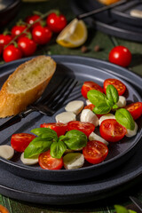 Caprese salad with cherry tomatoes, mozzarella, and fresh basil