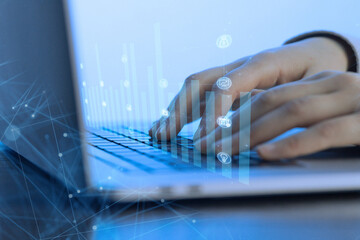 Hands typing on a laptop with digital graphics representing data and communication in a modern workspace setting