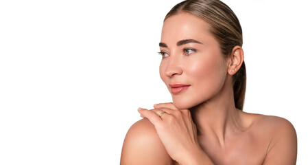 Woman with natural makeup posing gracefully against a plain background, highlighting her beauty and elegant features in a calm setting