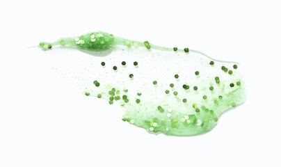Close-up of green glitter on white background with shiny particles highlighting texture and color.