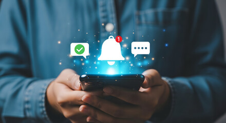 Person holding phone with glowing notification icons and bell