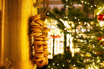 Festive pastries hang beautifully against glowing holiday lights, creating a cozy winter market...