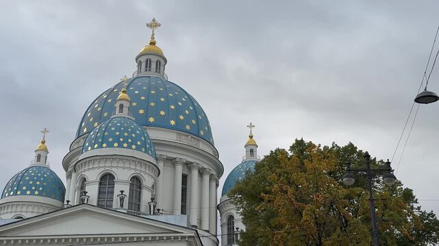 Video of birds circling above the blue domes with golden stars of the Trinity Cathedral (Troitsky Izmailovsky Sobor) on a cloudy autumn day