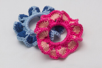 Colorful crochet scrunchies on white background with vibrant patterns