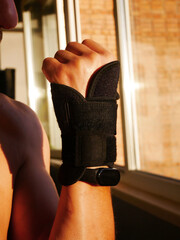 Hand with Wrist Brace and Smartwatch by Sunny Window