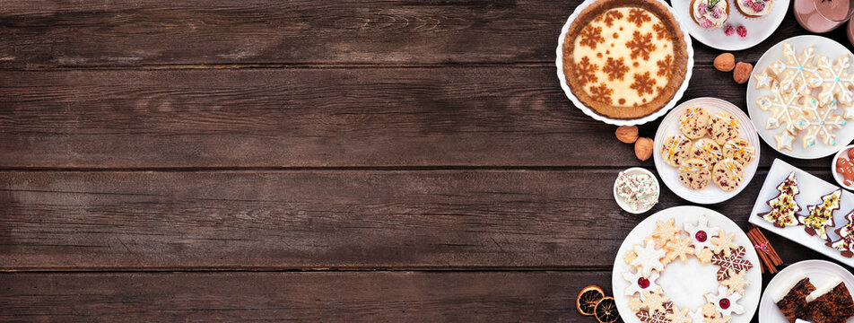 Christmas holiday cookies and desserts side border. Overhead view on a dark wood banner background. Eggnog pie, a variety of cookies, fruit cake, cupcakes and chocolate eggnog. Copy space. - Powered by Adobe