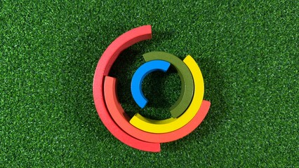 Wooden Rainbow Toy Blocks Stacked on a Green Background