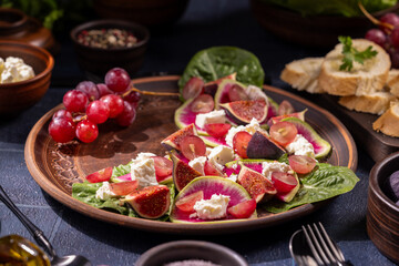 Salad with fig, feta cheese, grapes, watermelon radish