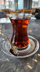 Turkish style brewed tea in a thin waisted glass cup