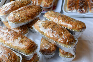 Freshly baked poppy seed loaves wrapped in plastic for sale