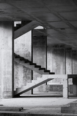 Black and white photo of a building site. Shows the tectonics of reinforced concrete stairway....